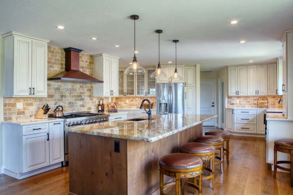 Crest Kitchen – Featuring Durasupreme Knotty Cherry raised paneled cabinets and natural stone countertops