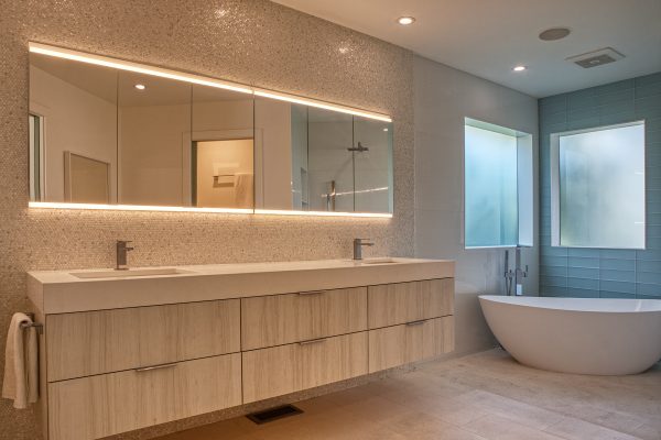 Penny Round Bath – Featuring cabinetry by DuraSupreme, Ceasarstone in Vivid White for countertops, Floor tile by Haussman in Lime Stone (H). Solistone mother of pearl penny round tile for the backsplash, with Mercato glass tile in the color of Tiburon surrounding the tub.